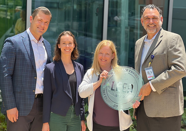 MemorialCare leadership and LEED representative stand with LEED Gold plaque in-front of Children's Village
